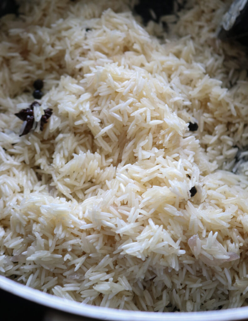 adding basmati rice to the tempered ingredients.
