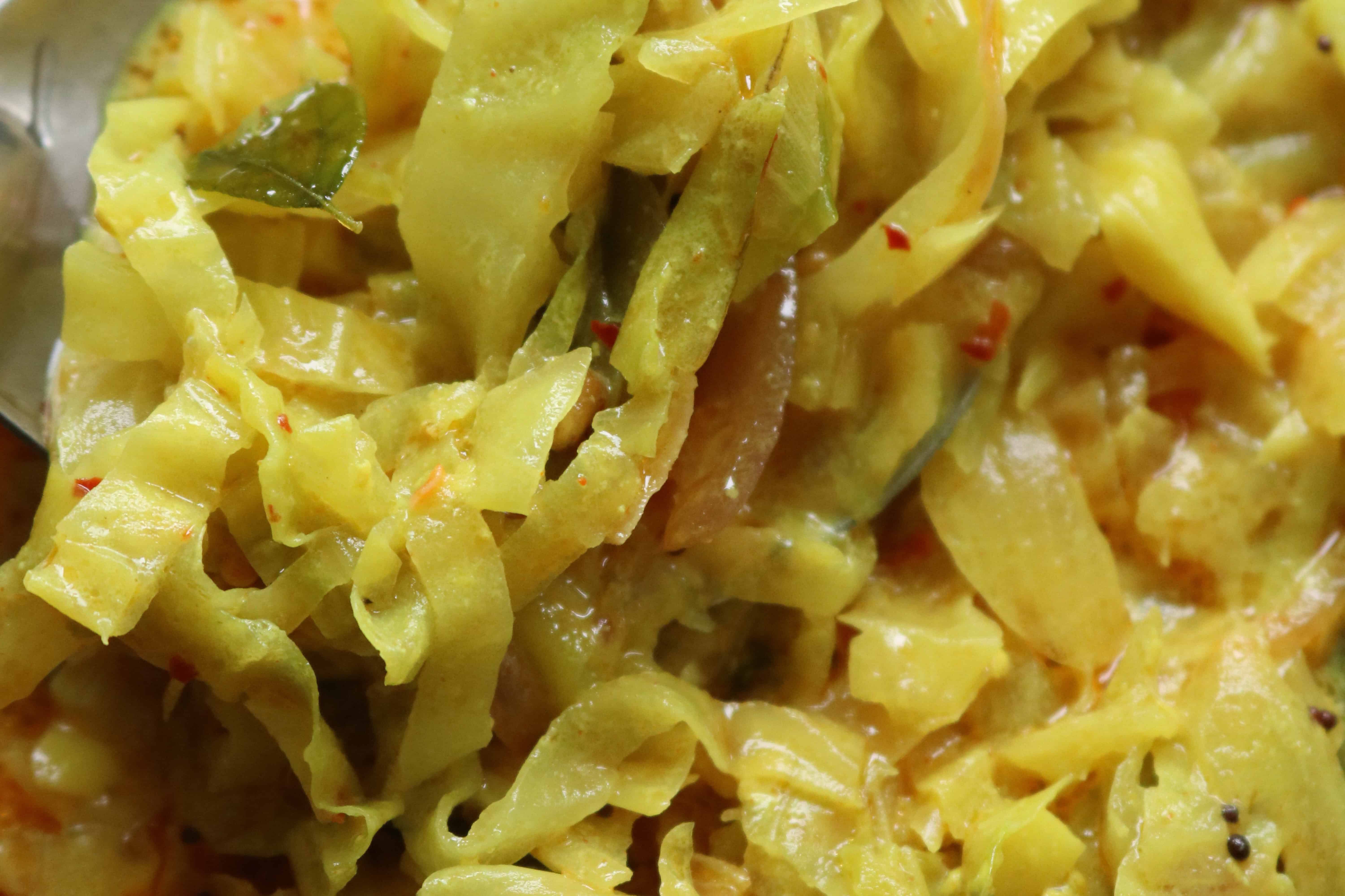 Cabbage coconut milk scooped up with a spoon