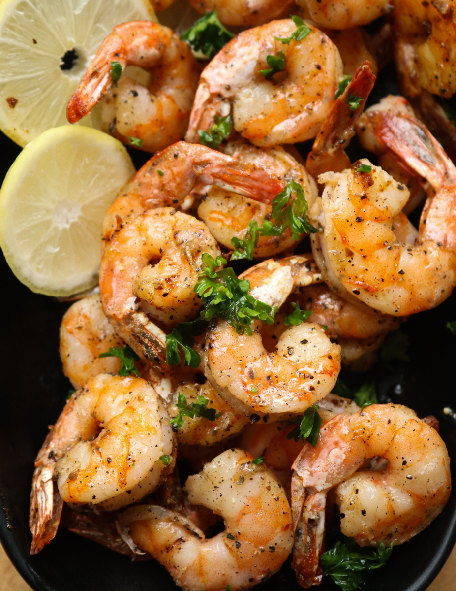 air fryer shrimp in a bowl with lime wedges