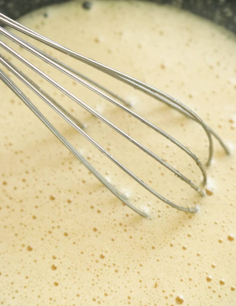 whisked egg and sugar to a frothy consistency to make the pineapple bread pudding.