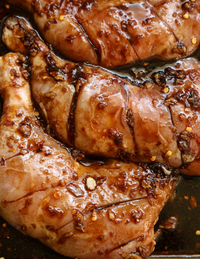 chicken quarters  marinating in teriyaki sauce.