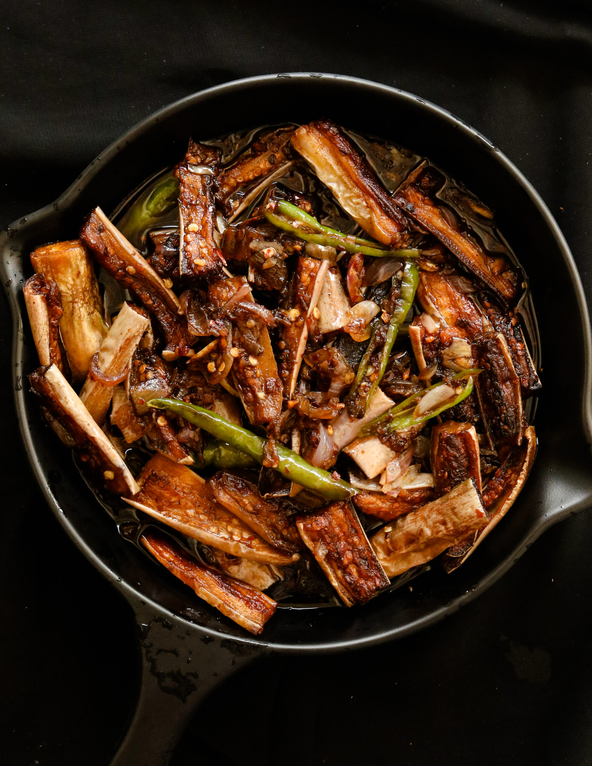 eggplant stir fry served in a black platter.