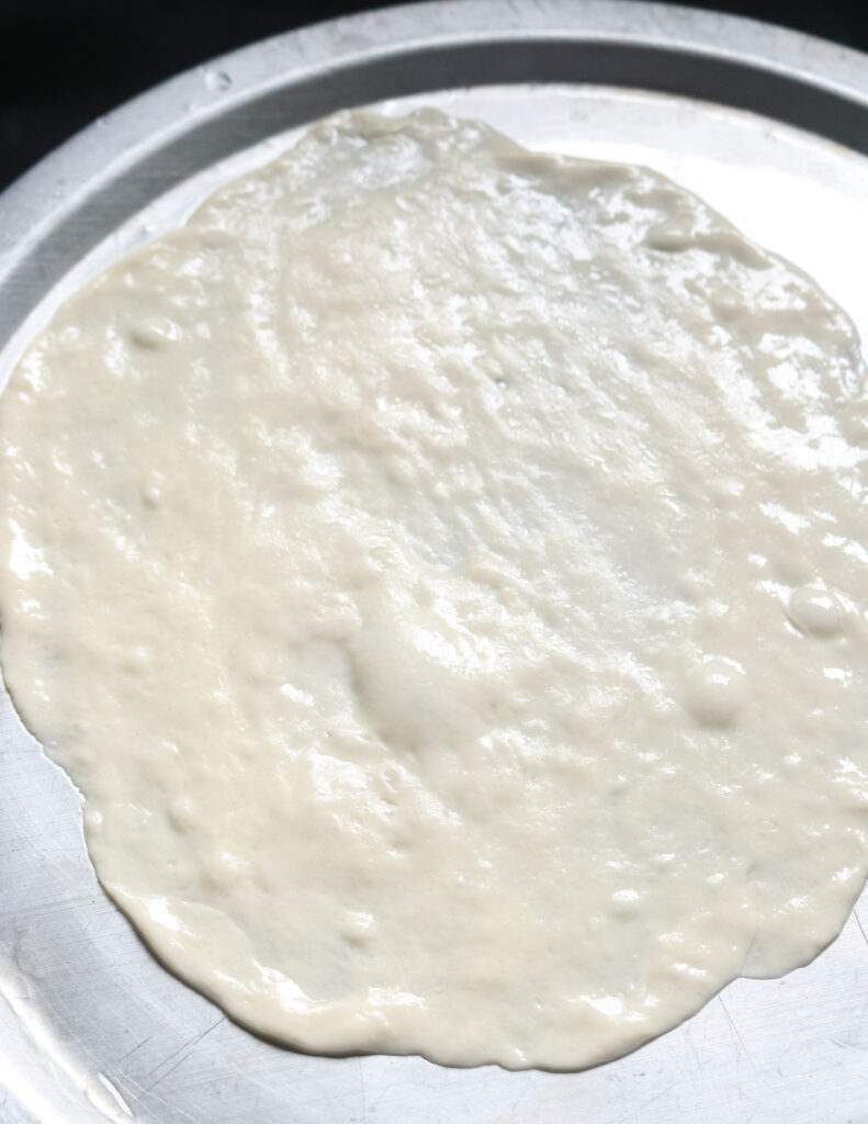 spreading the paratha dough.