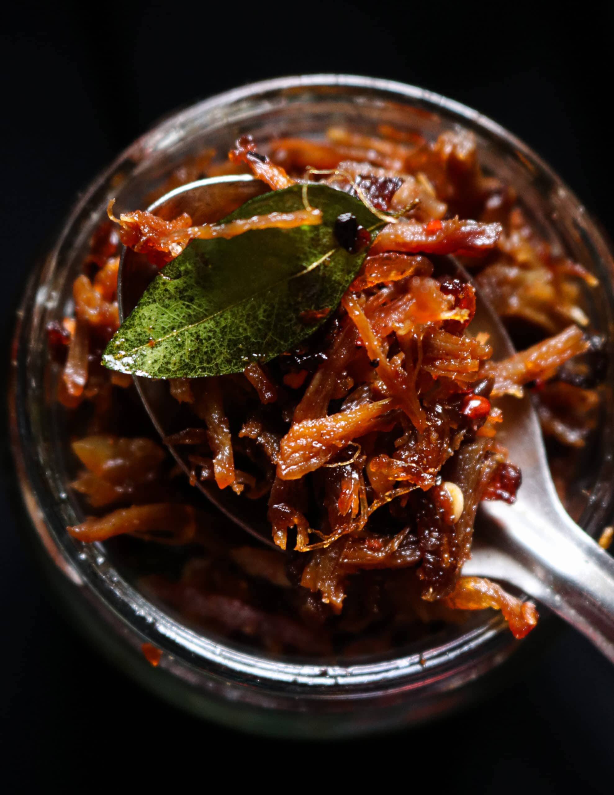 taking a spoon of shredded beef fry sambol.