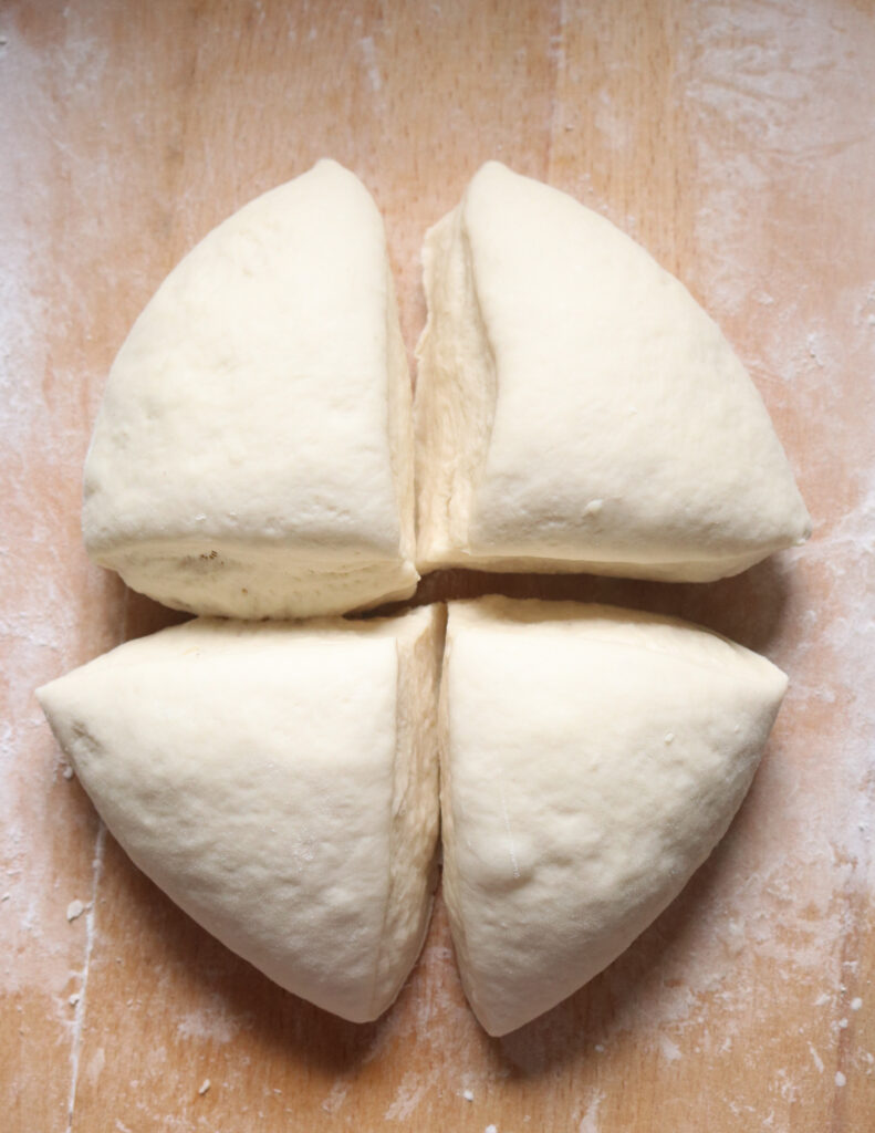 cutting the dough in four to make the kibula banis
