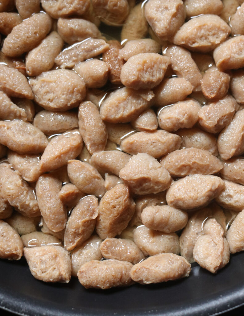 uncooked soya meat in hot water ready to be cooked.