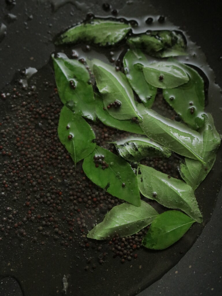 curry powder and mustard seeds fried in oil to cook the spicy pineapple curry.