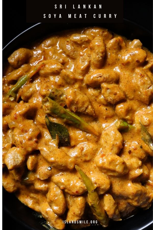 cooked Sri Lankan soya meat curry in a bowl with curry leaves and green chillies.