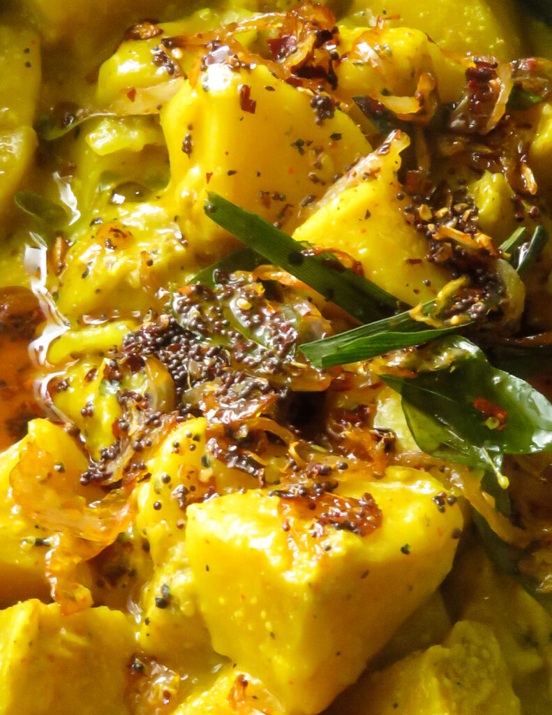 cooked bread fruit curry recipe with fried onions, mustard seeds and curry leaves to cook the bread fruit curry.