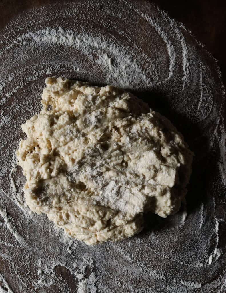 flour and yeast mixed dough on a floured board.