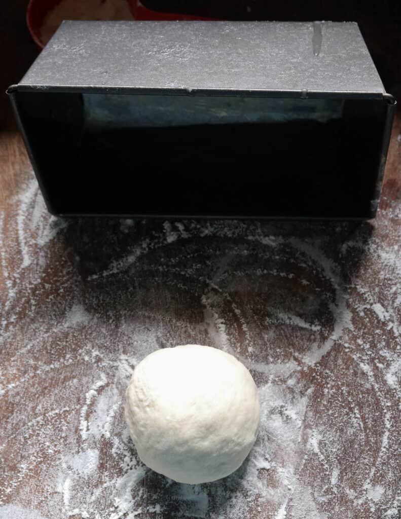 smooth dough ball with the loaf pan to make roast bread.
