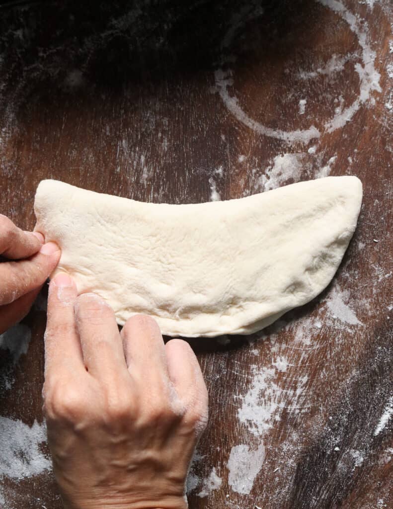 pinching the edges of the shaped roast paan.