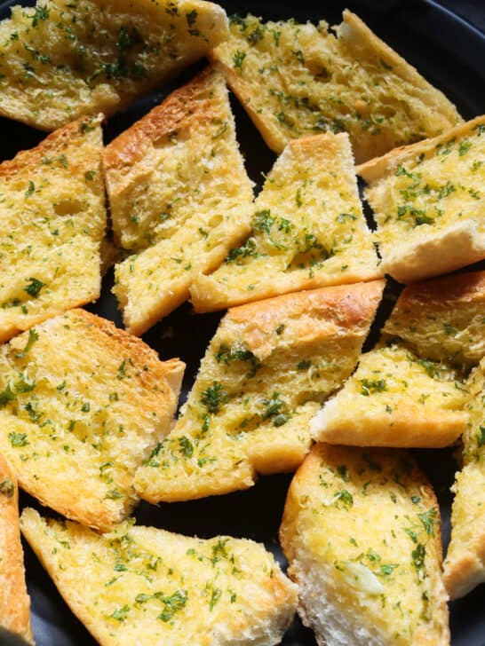 crunchy garlic bread served on a platter