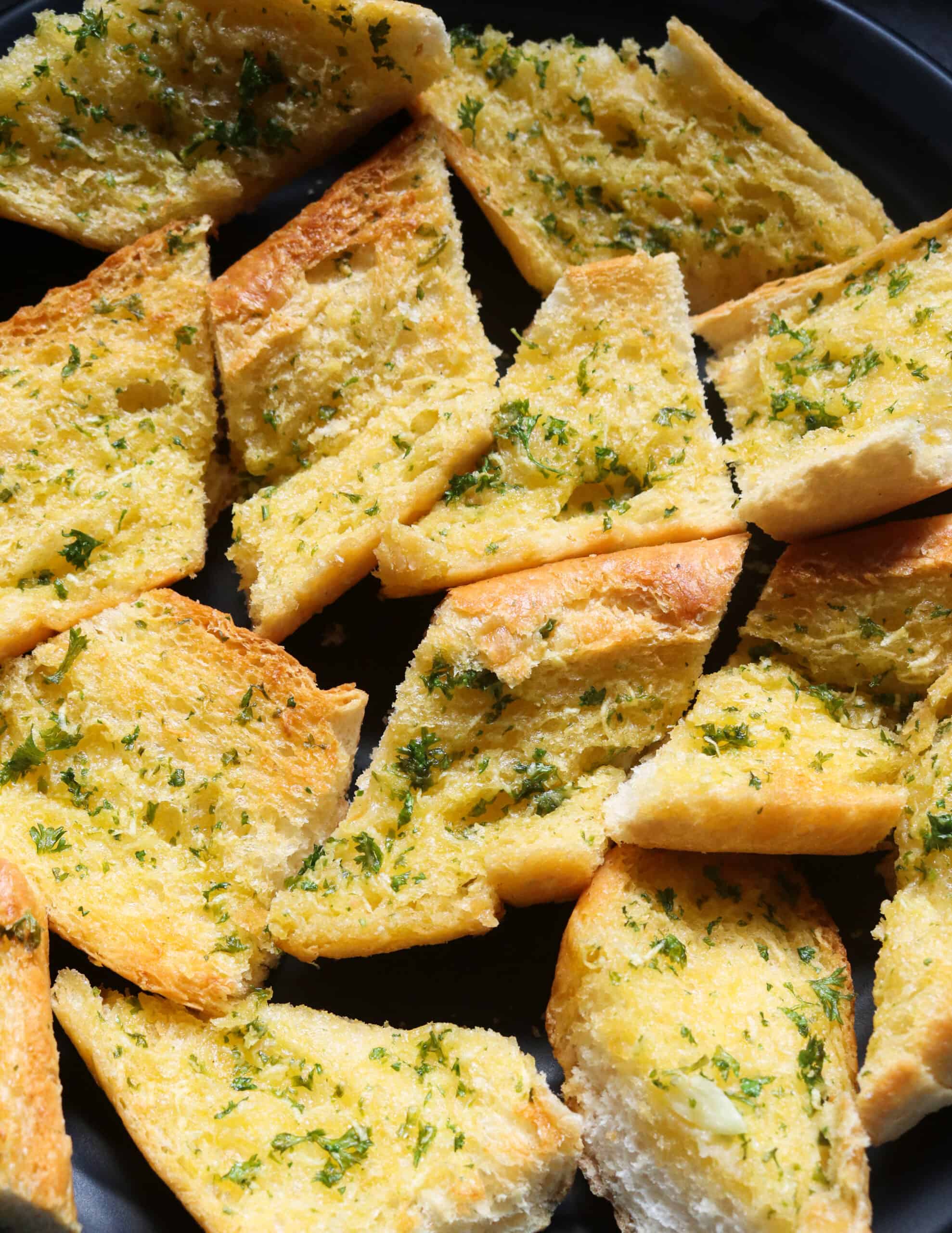 crunchy garlic bread served on a platter