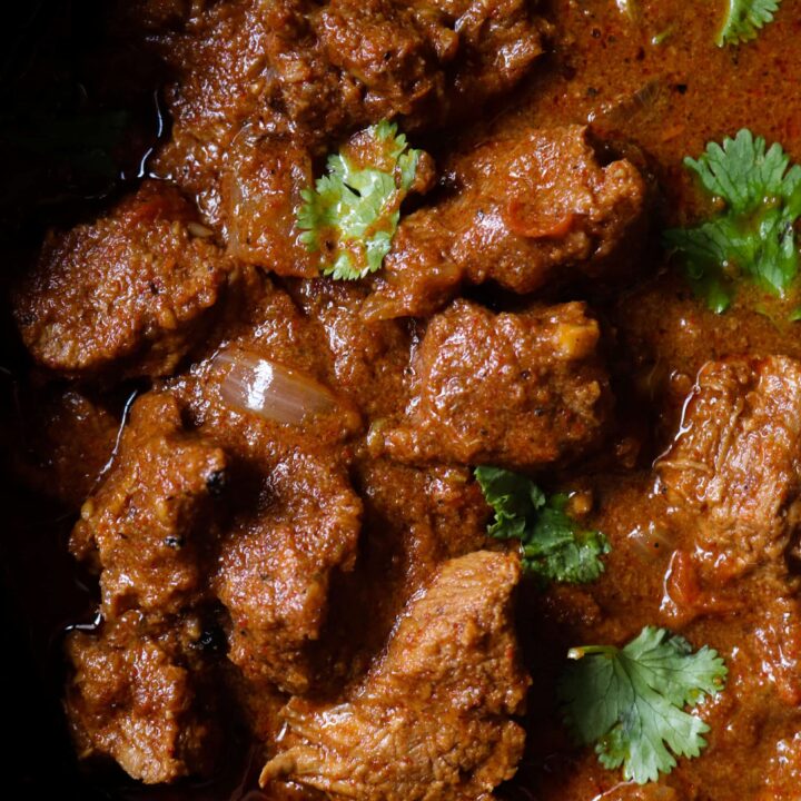 beef vindaloo curry garnished with coriander leaves.