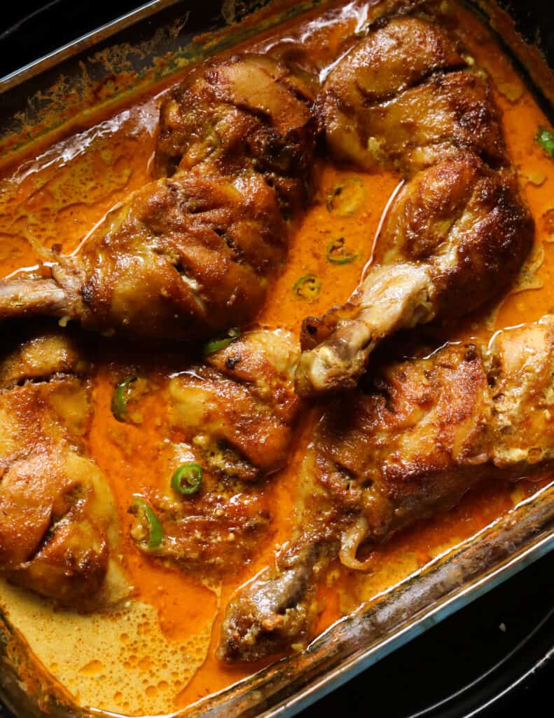 baked chicken quarters with a thick gravy baked in a pyrex dish.