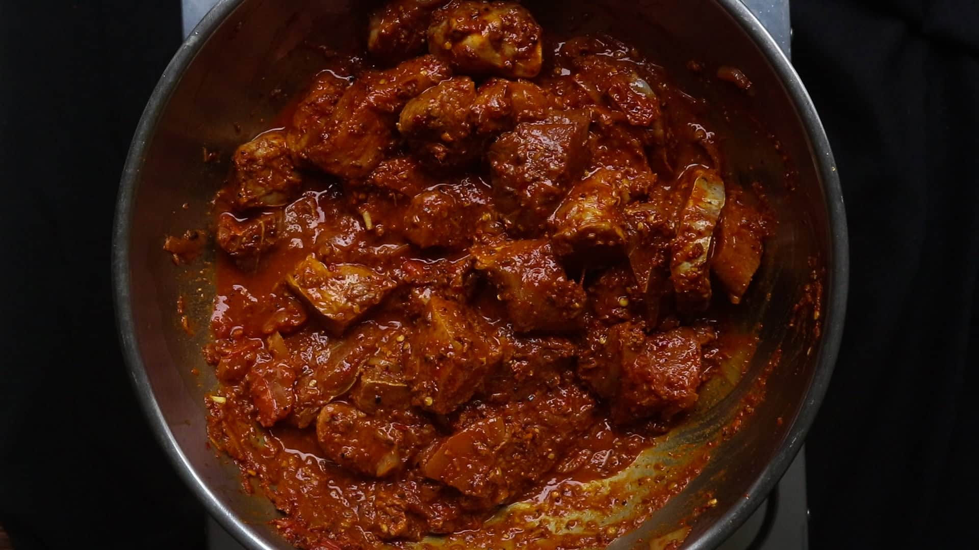 add the beef to the masala spices to cook beef vindaloo.