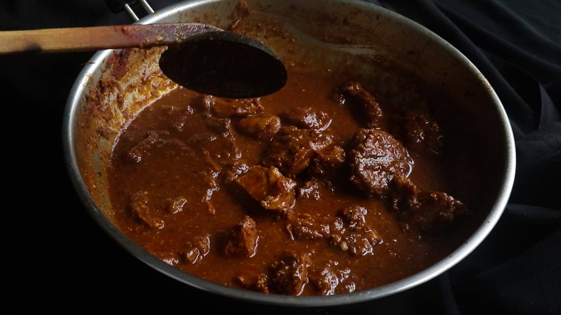 beef vindaloo curry cooked in a wide mouthed pan.