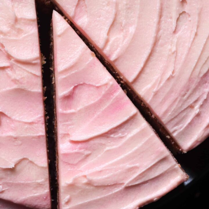 swirled pink icing on a neopolitan marble cake.