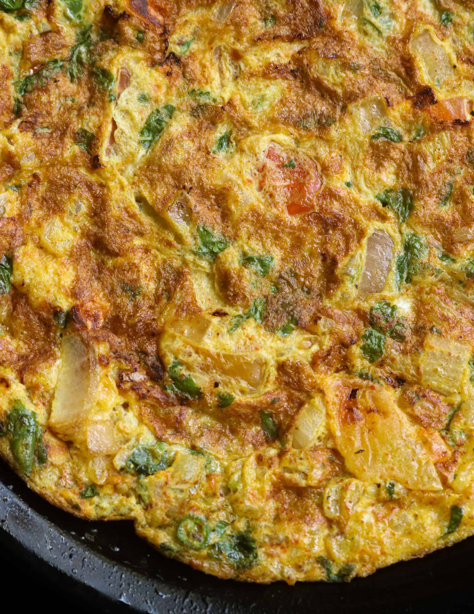 masala omelette with coriander leaves, onions, tomatoes and curry powders.