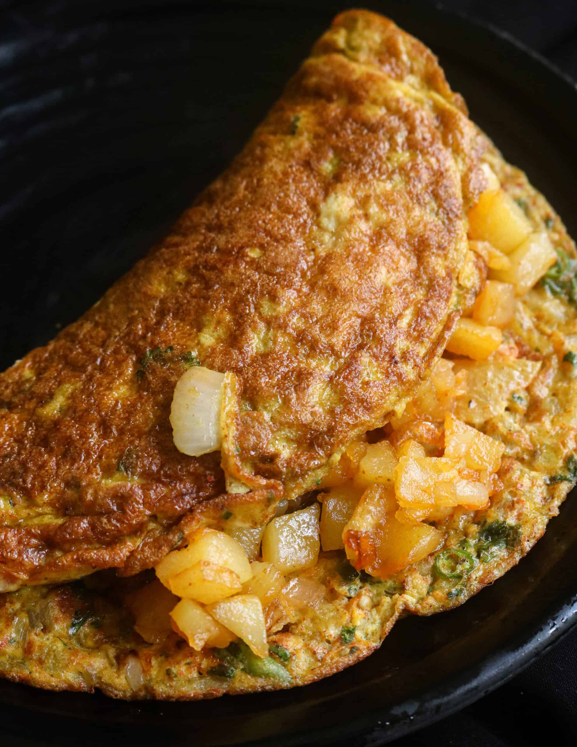 Indian masala omelette stuffed with fried potatoes for variation.