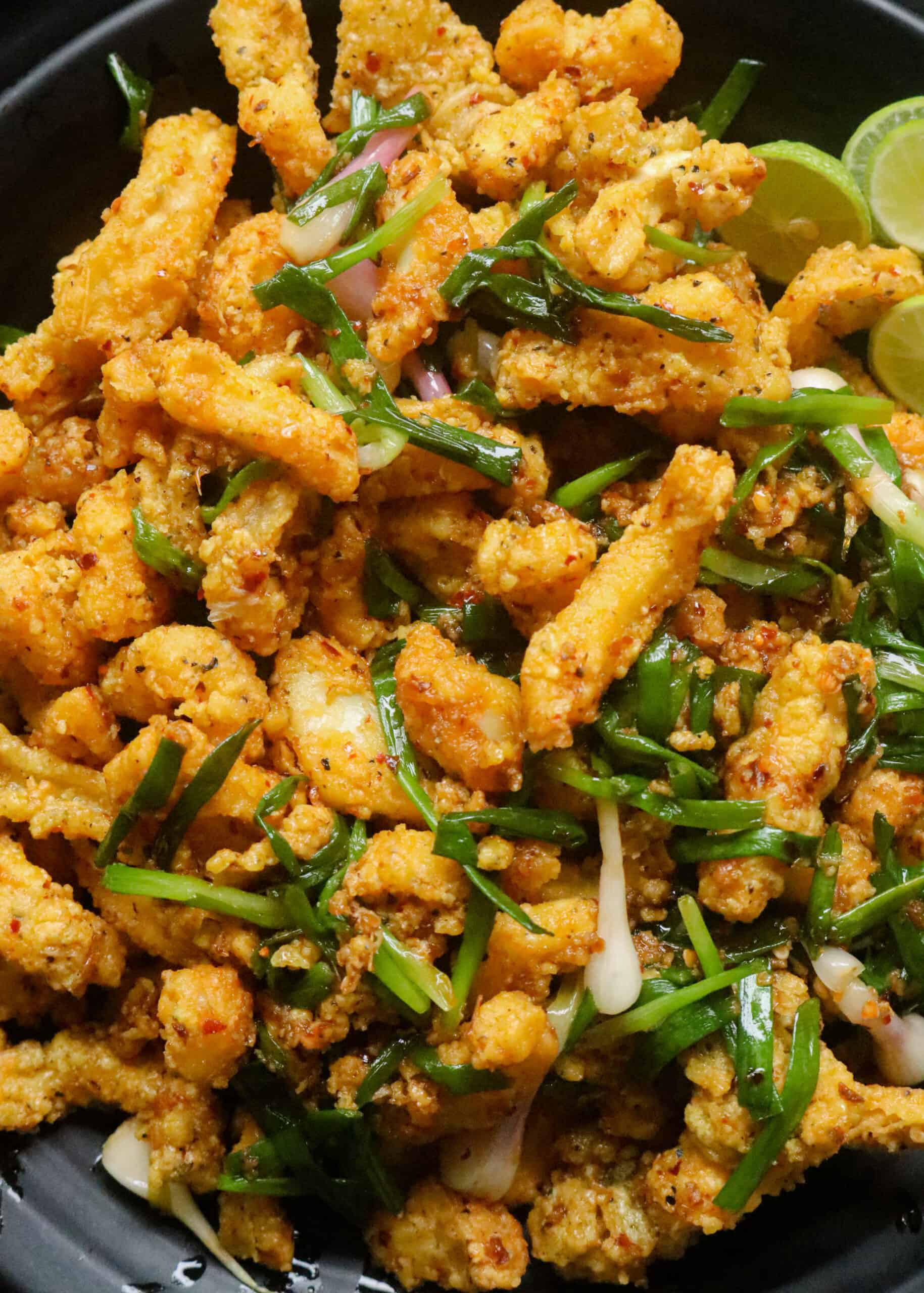 platter of crispy hot butter cuttledish with scallions.