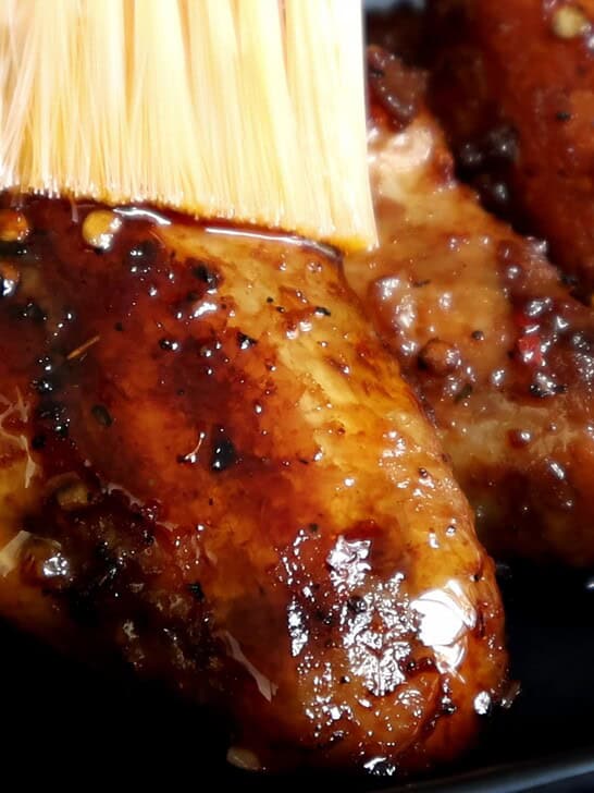 brushing the chilli garlic oil over the shallow fried wings.